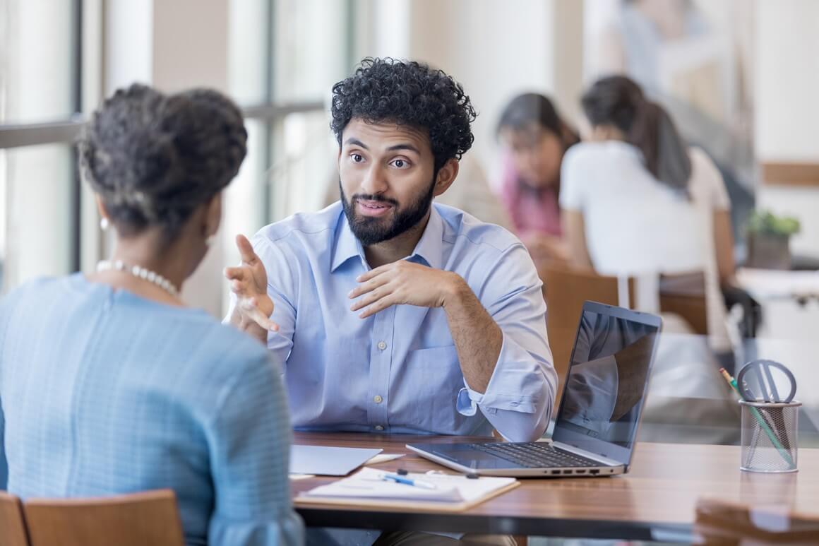 Young adult talking to a career advisor at a hiring event