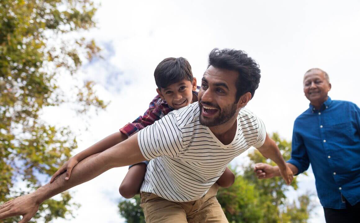 Father giving son a piggy back ride